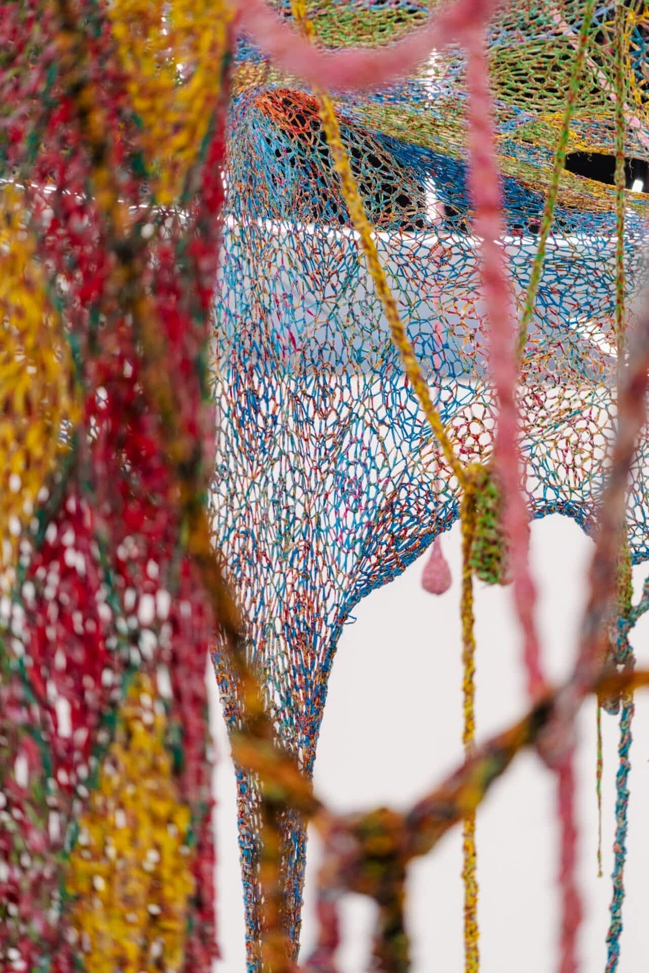 layers of crocheted chintz fabric in a large museum installation