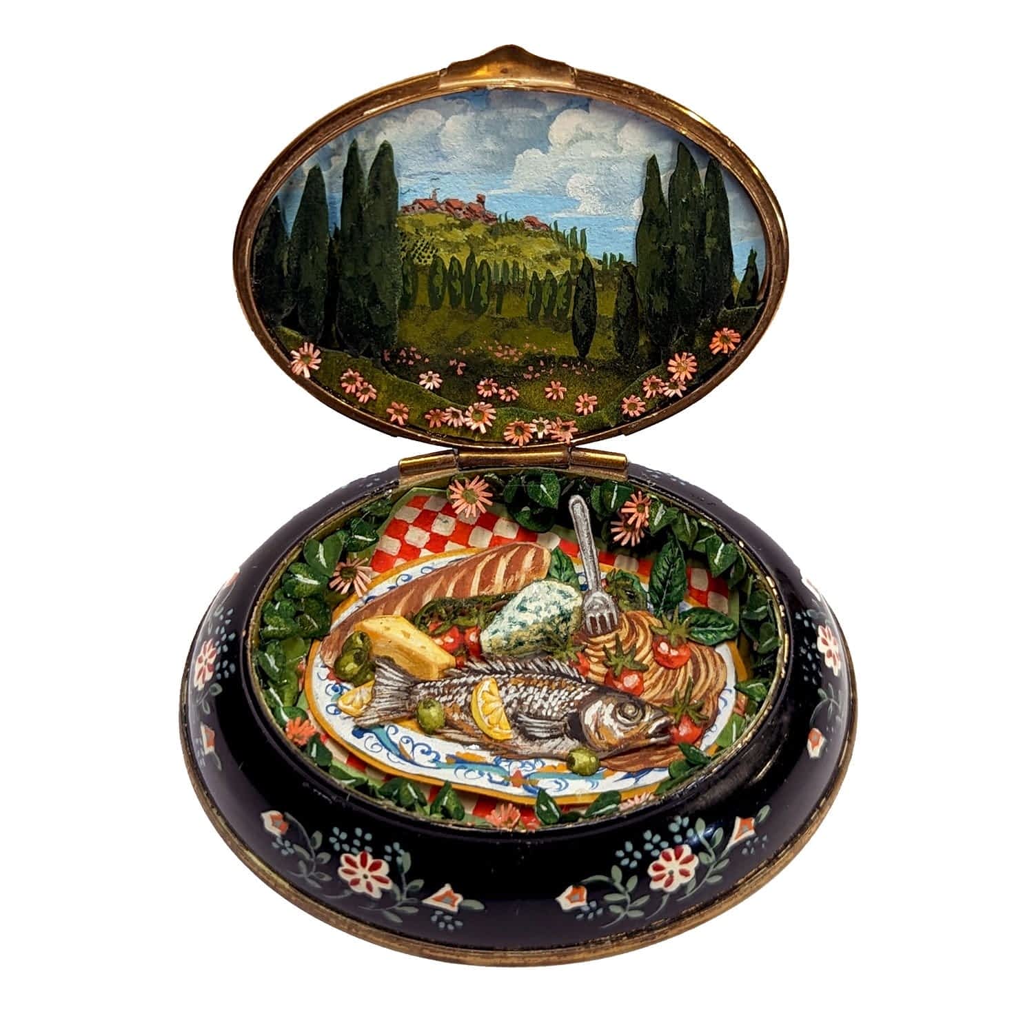 a tiny diorama made from watercolor-painted paper inside of a vintage cosmetics compact depicting a pastoral Italian countryside scene on top and a dedacent spread of fish, pasta, and cheese in the bottom