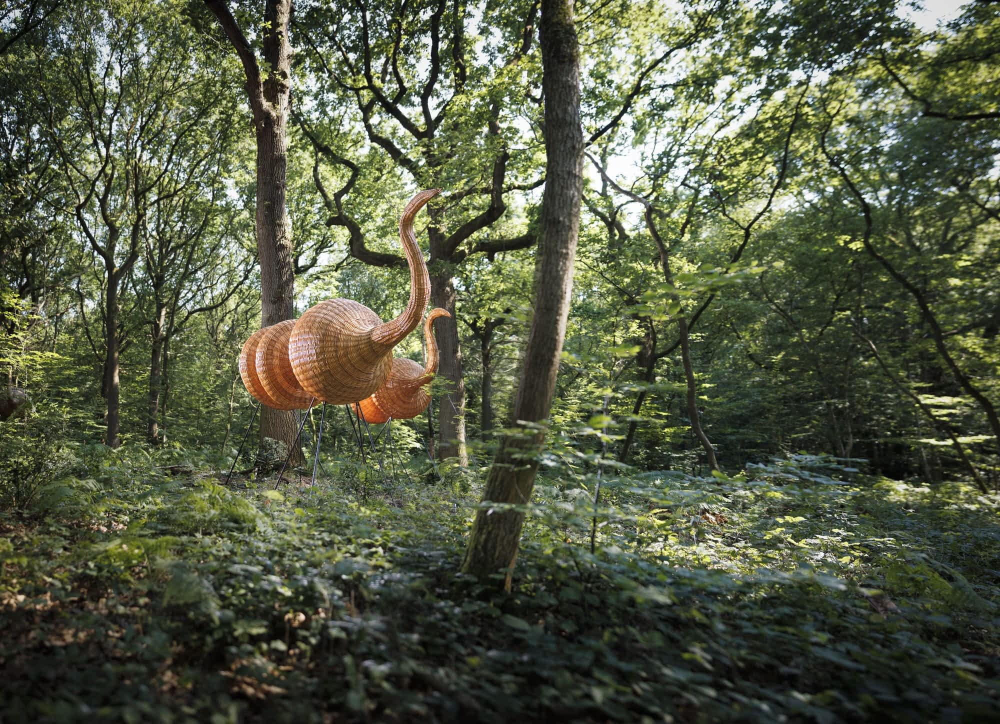 two wooden camels stand in a forest