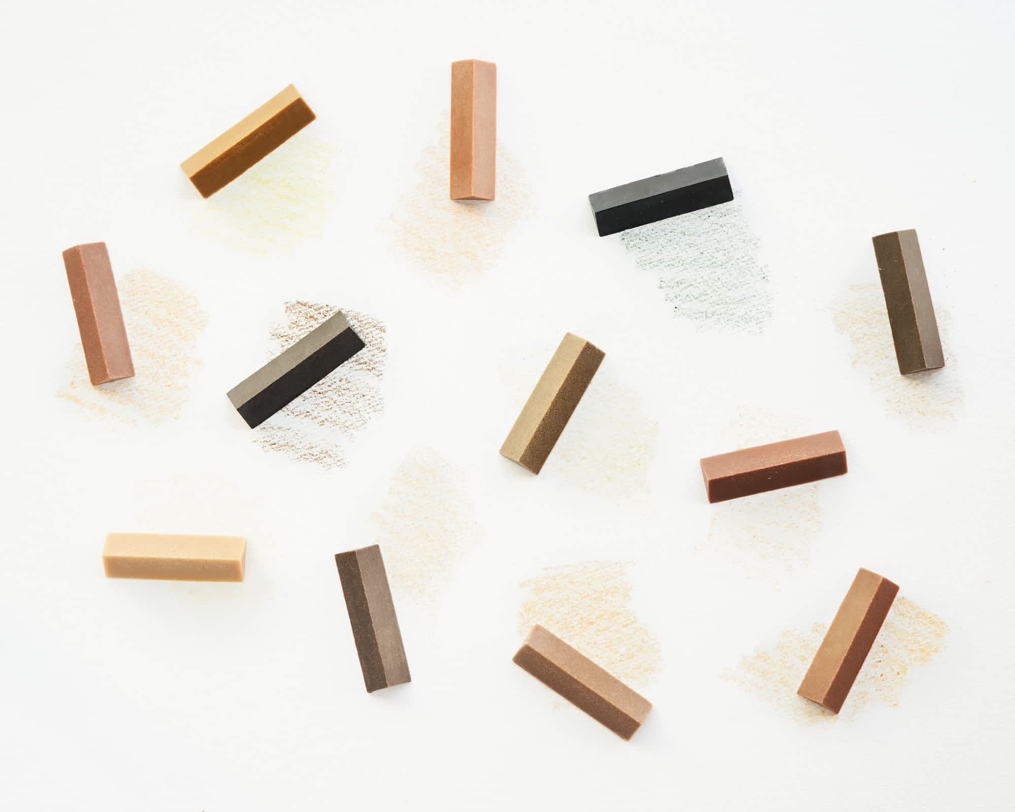 an array of colorful, triangular crayons made from the naturally occurring colors of wood from different trees