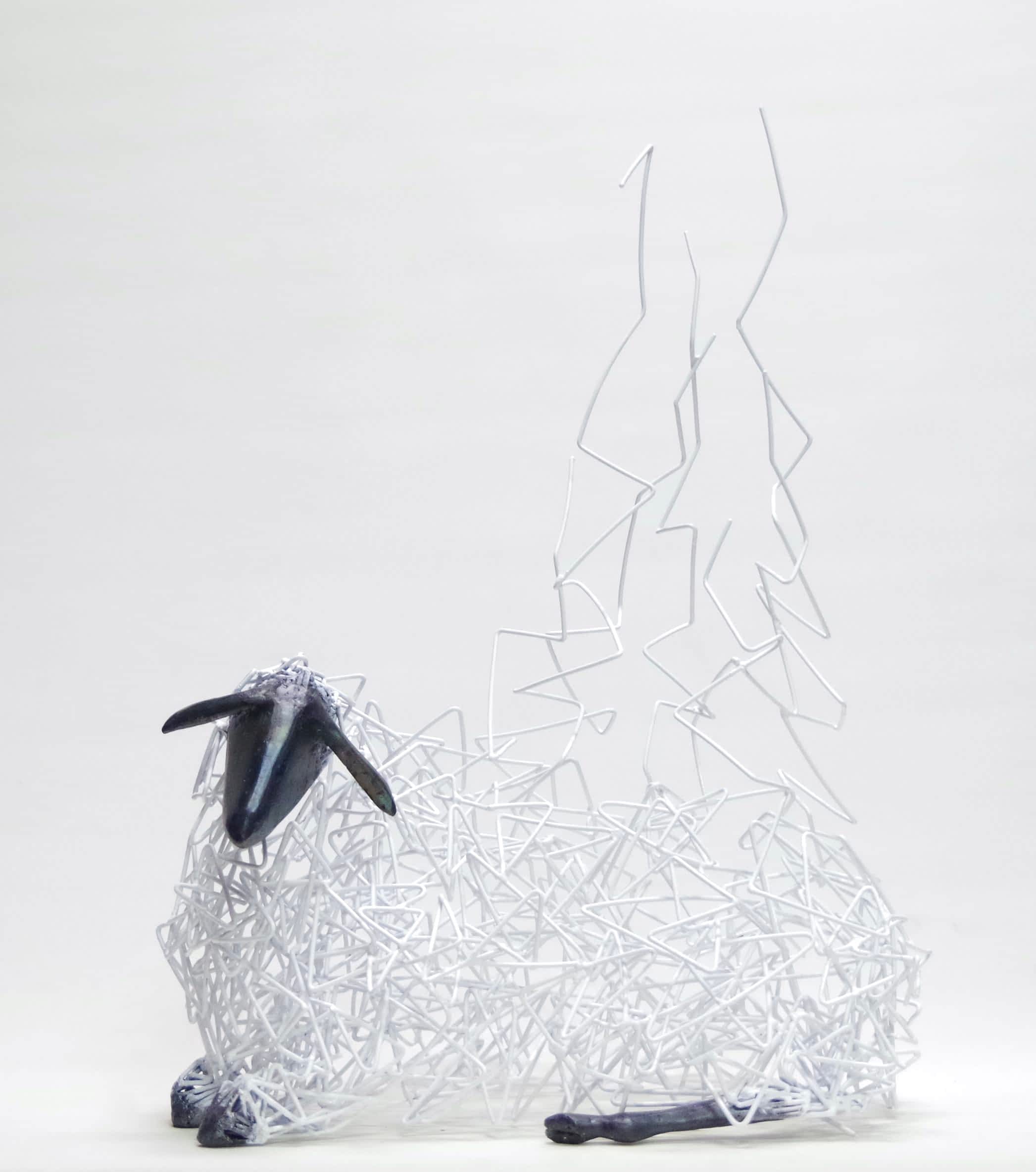 a sculpture of a seated sheep with its center turning into tendrils leading toward the sky as if it is disintegrating upward