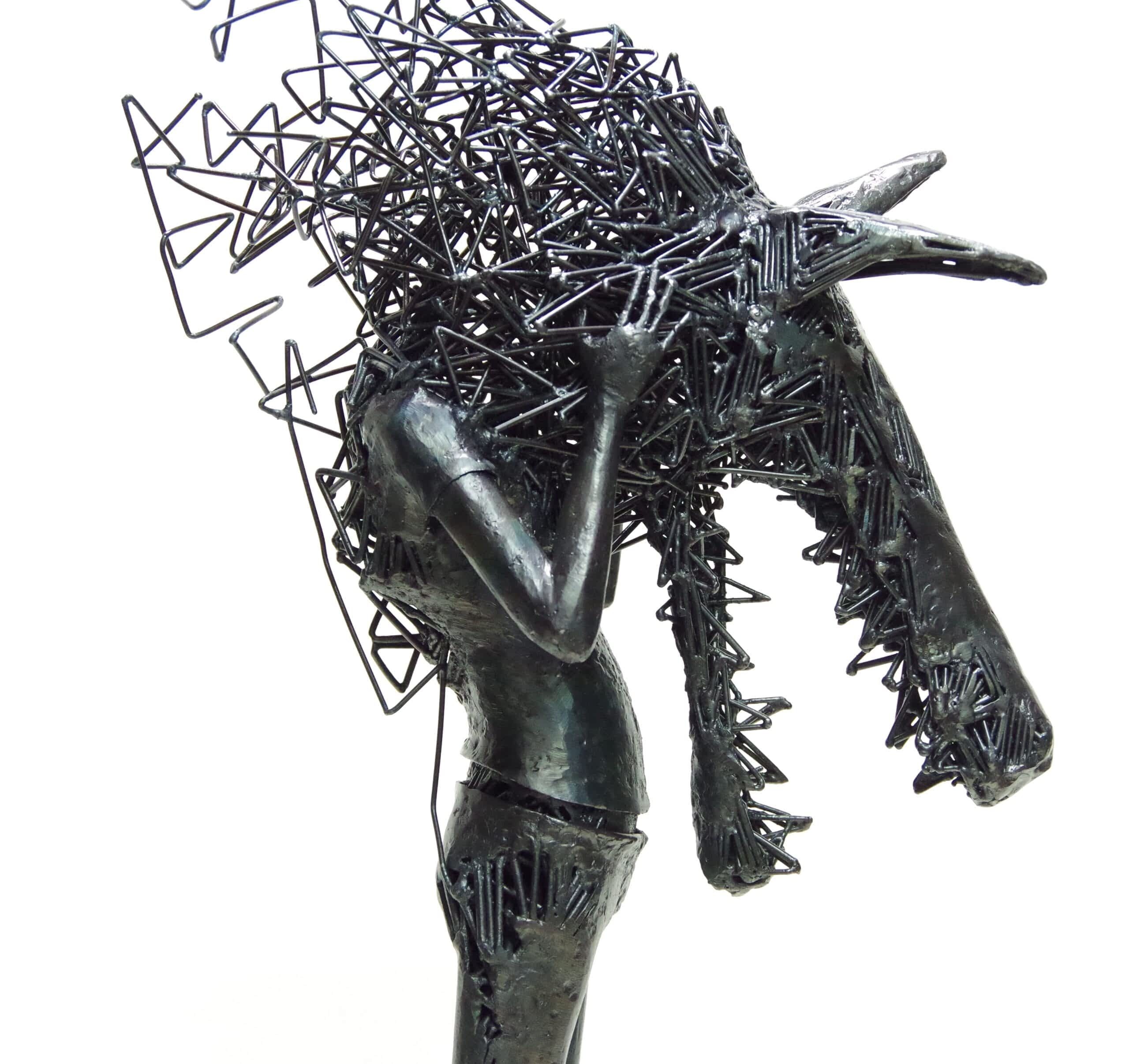 a metal sculpture of a young figure wearing an abstract wolf head