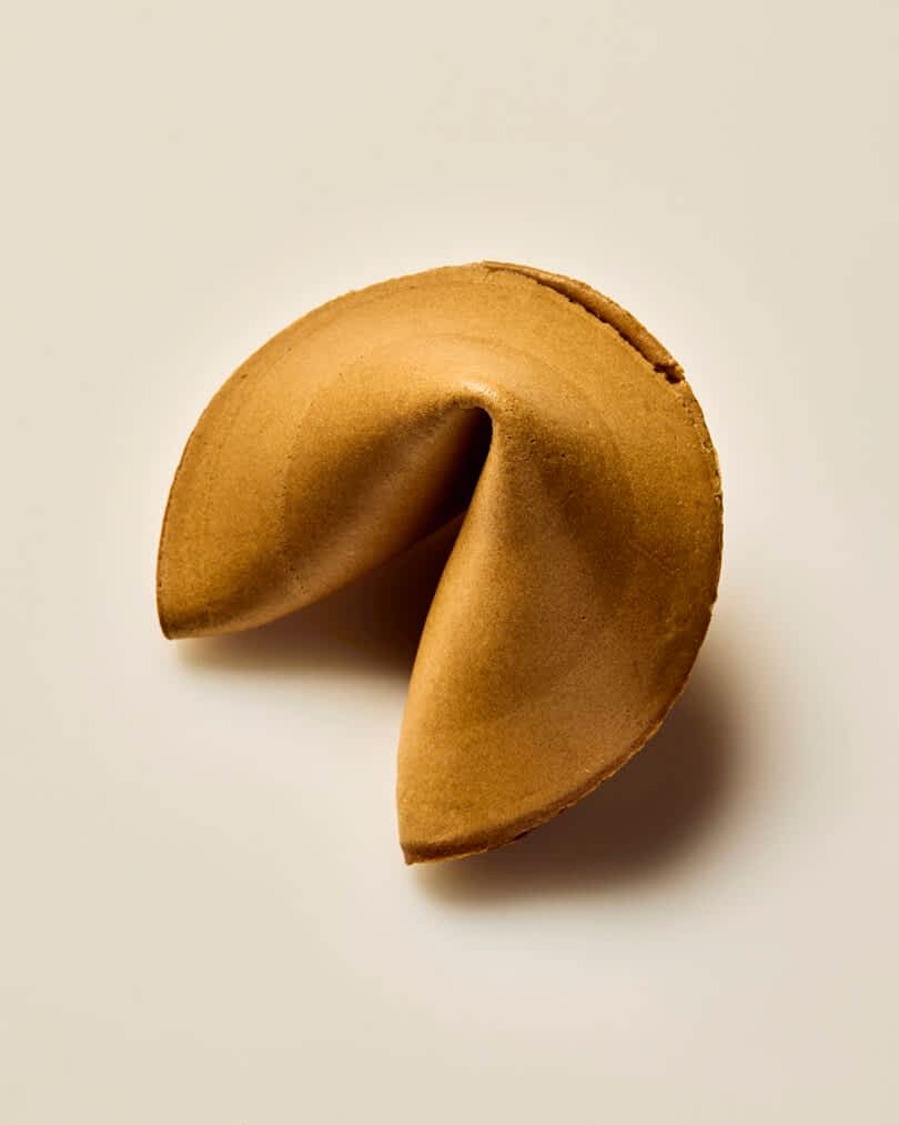 A fortune cookie on a plain white background.