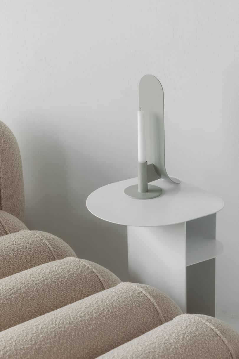 Modular modern seating with textured upholstery and a white side table.