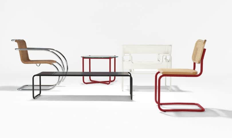 A group of modern furniture pieces including two chairs, a bench, and a side table, all featuring minimalist designs with metal frames and clean lines, set against a white background.