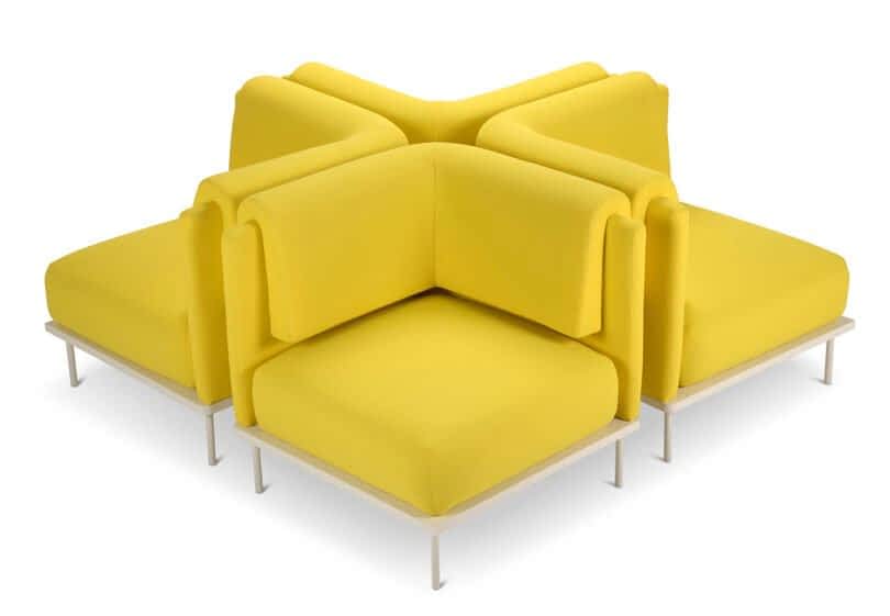 Four modular, bright yellow chairs arranged in a cross formation with metal bases.