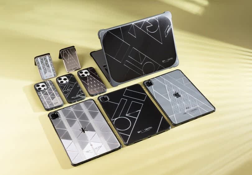 Assorted electronic device cases, including Casetify phone covers with geometric patterns, are displayed on a light yellow background under soft lighting. The cases include options for smartphones, tablets, and laptops.