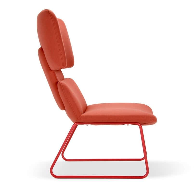 A side view of a modern lounge chair with red cushioned backrest and seat, supported by a red metal frame.