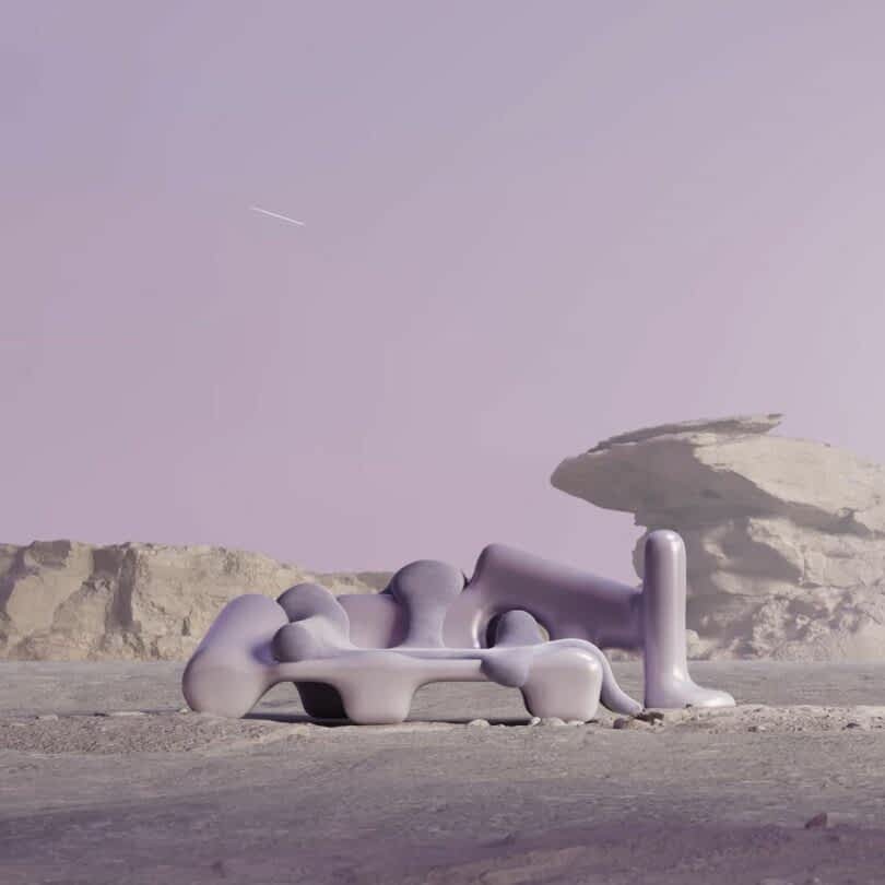 A surreal, abstract sofa sits in a barren, rocky landscape under a pale purple sky with a faint shooting star visible above