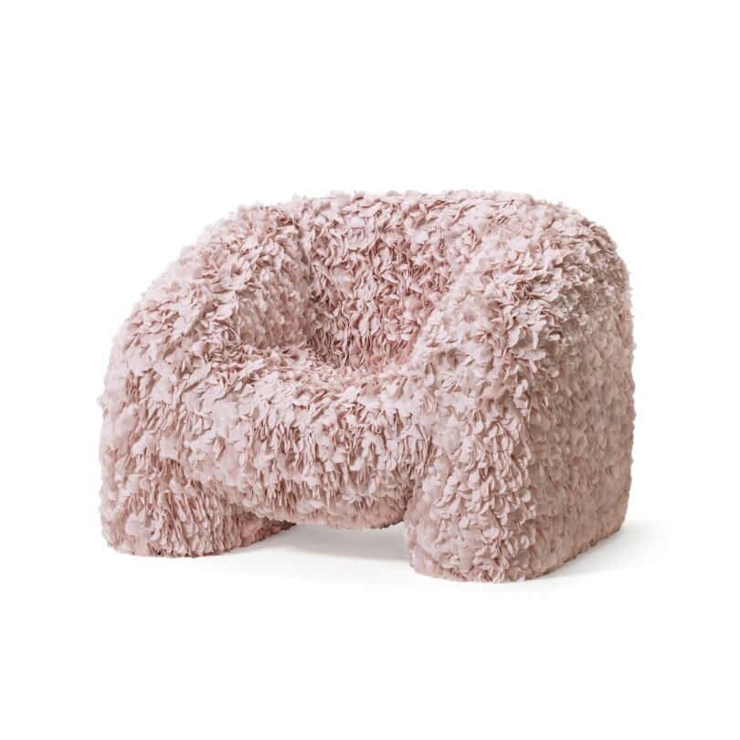 A soft and fluffy pink armchair with a textured, petal-like fabric covering