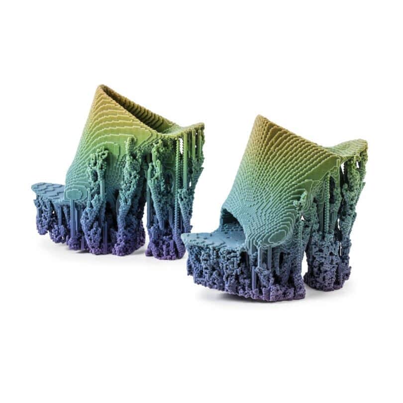 A pair of high-heeled shoes with intricate, pixelated textures and a gradient color scheme from green to purple