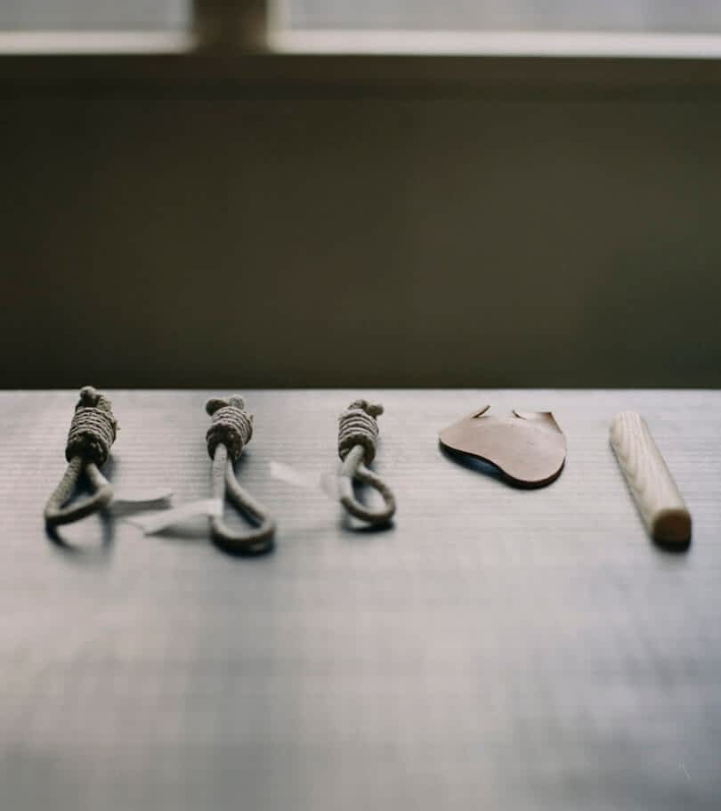 rope, leather, and wood scraps on a table