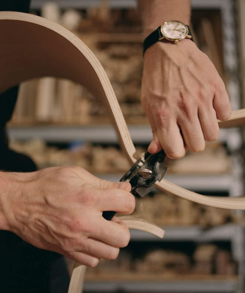 hands screwing a nail on rocking horse
