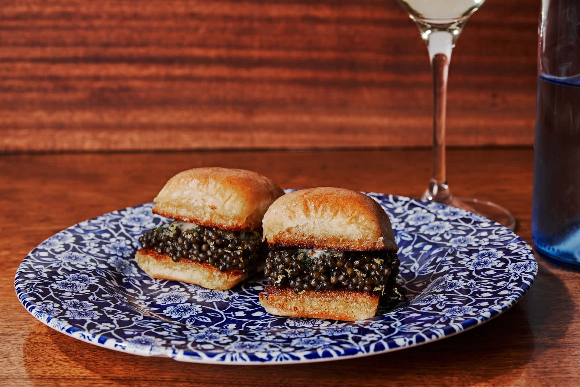 Chubby Fish Two buns filled with caviar sit on a plate.