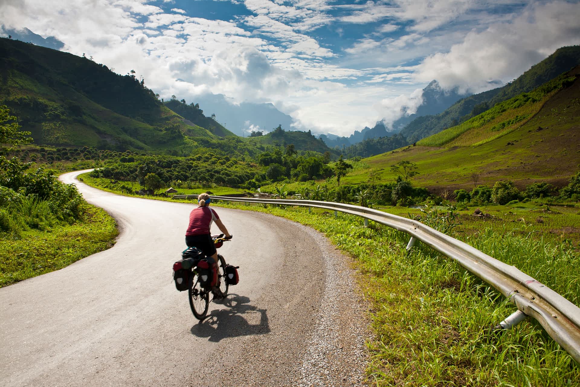 Cyclist riding on a road in Laos 