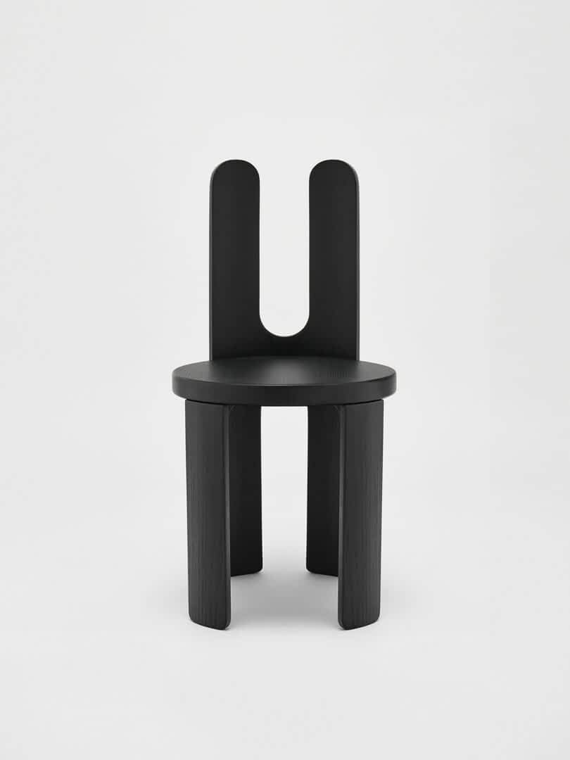 A modern chair with a dark wood finish and a unique, dual backrest design.