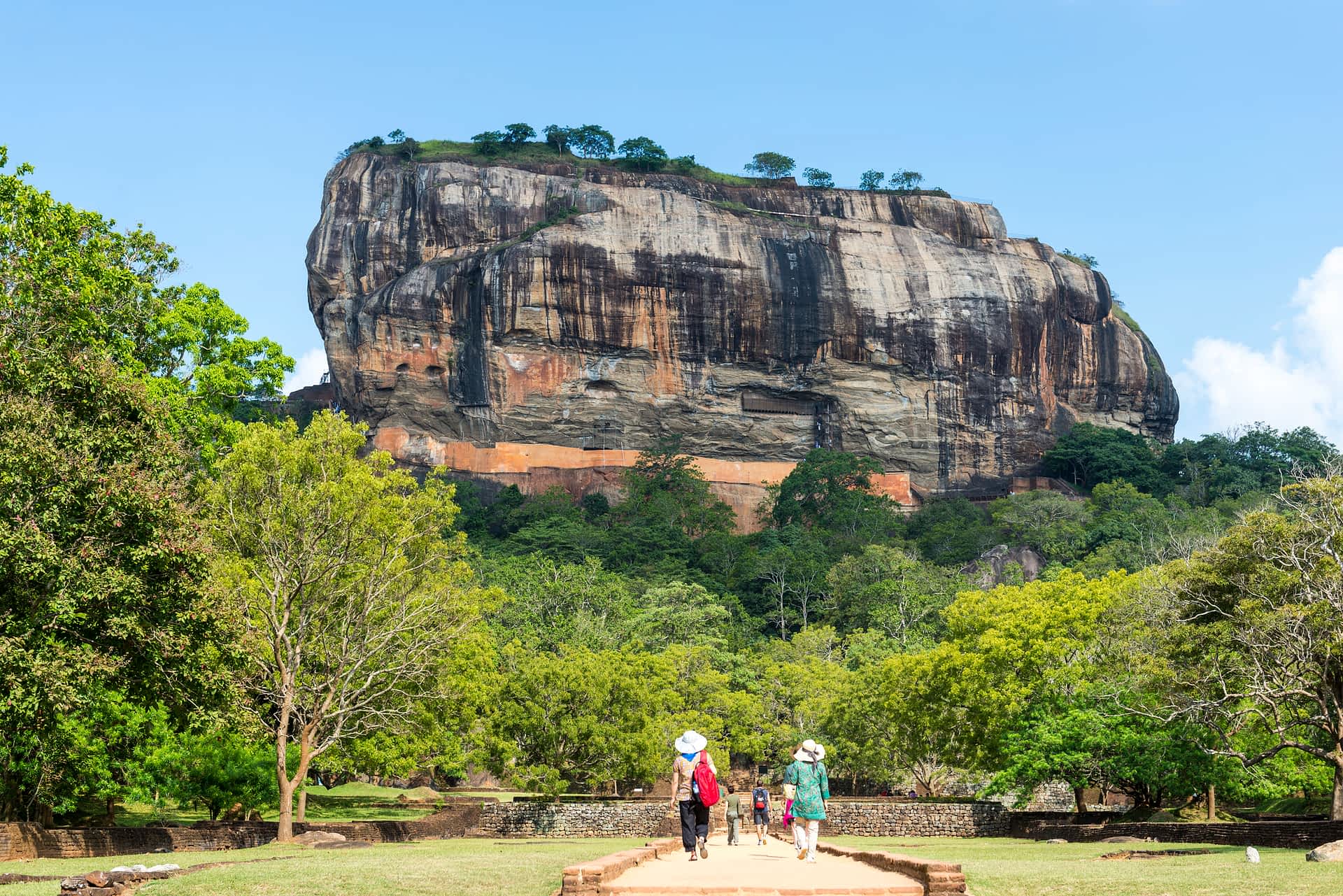 Sigiriya is one of Sri Lanka's most dramatic ancient sites. Visitors walk through gardens to the rocky ruins of Sigiriya, Sri Lanka.