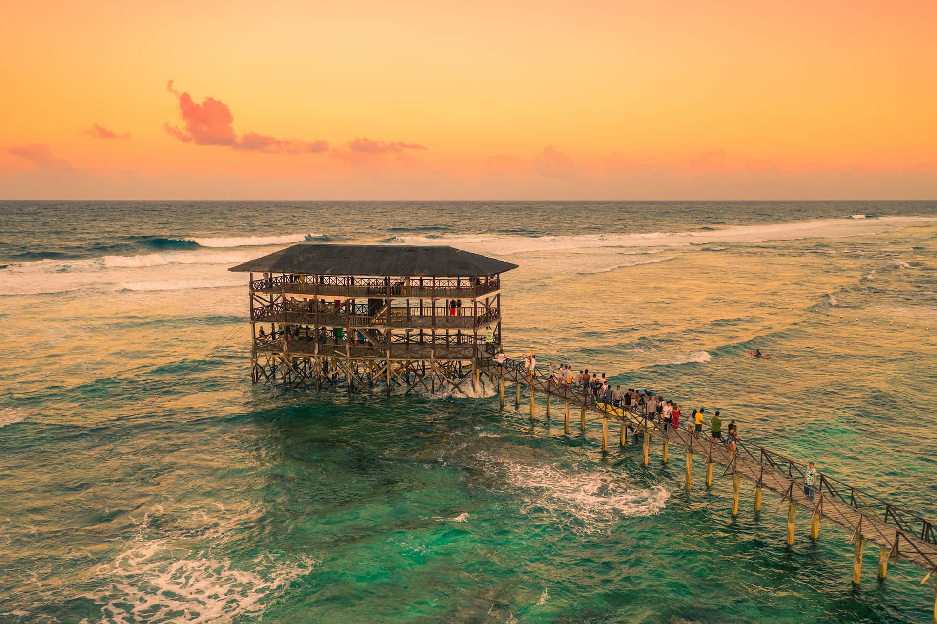 GettyImages-1357457095.jpg A large multi-level wooden structure and walkway our to sea near a surf spot