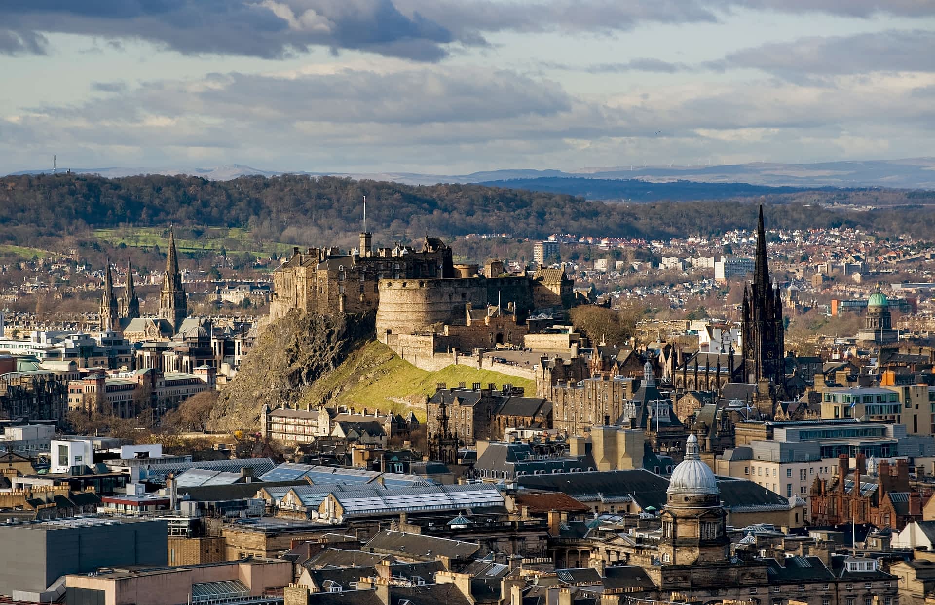 Edinburgh Castle looms handsomely over the center, calling out to be explored. The skyline of central Edinburgh, dominated by Edinburgh Castle.
