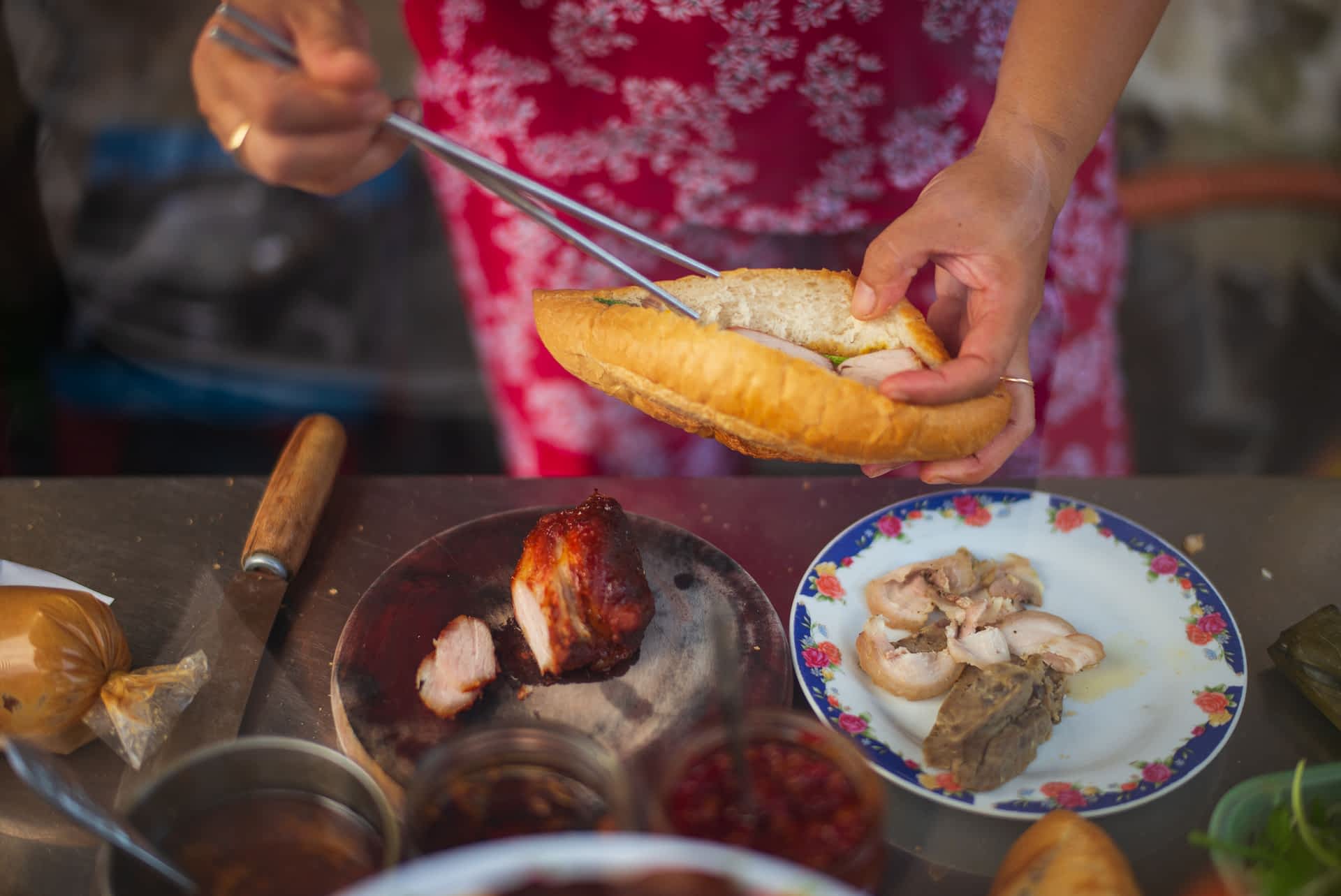 Ho Chi Minh banh mi Vietnamese woman preparing street food Banh Mi in Vietnam
