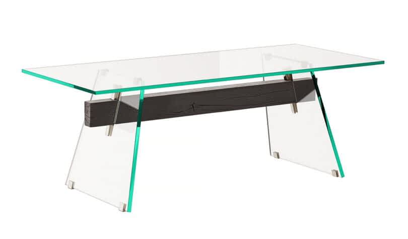 A glass dining table with a rectangular top and clear angled glass legs, featuring a horizontal black wooden beam for support.