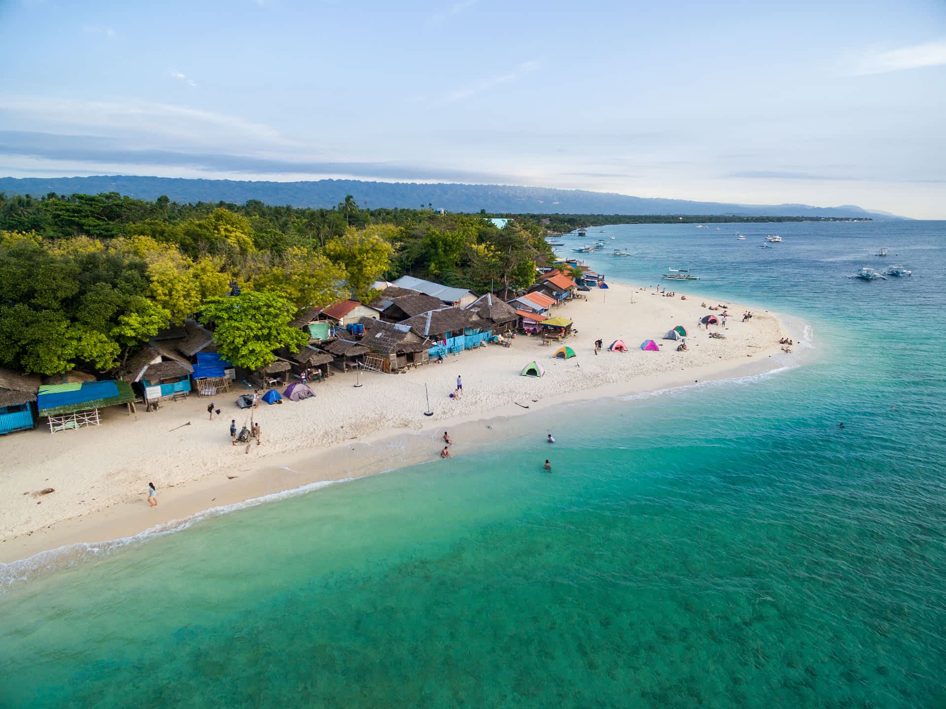 The long sands of White Beach at Moalboal on Cebu Island A view of White Beach at Moalboal on Cebu Island