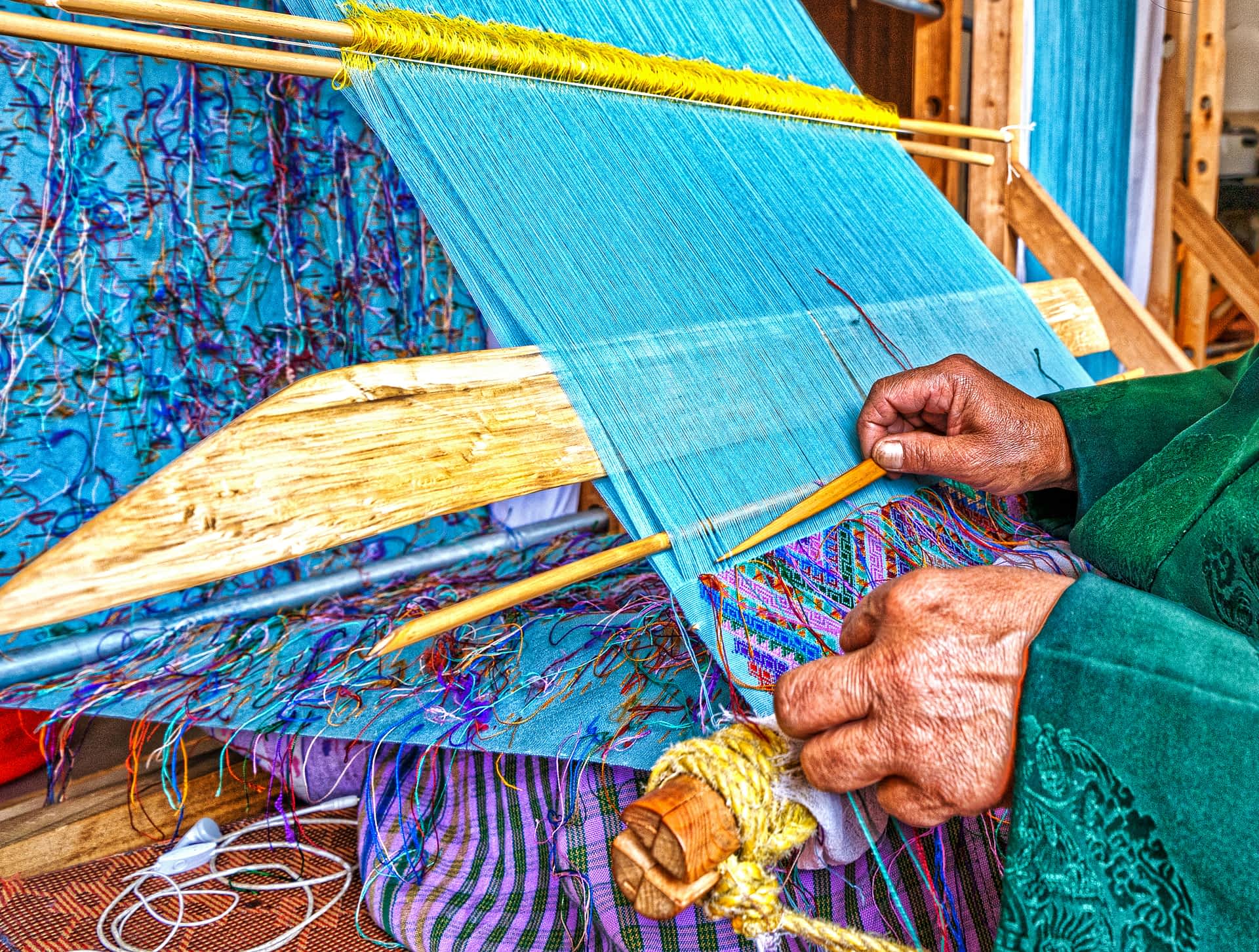 Traditional weaving in Bhutan Hands of a woman weaving in Bhutan