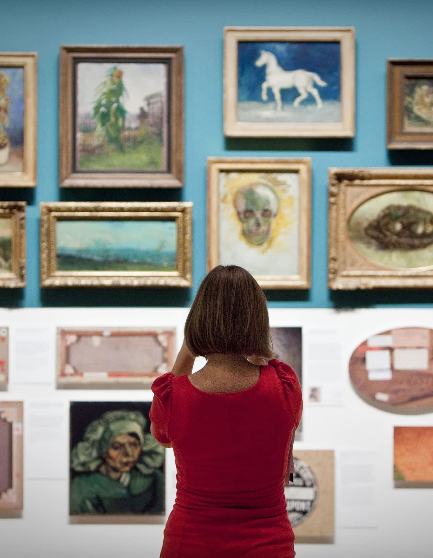A woman looks at paintings of dutch pain A woman looks at paintings of dutch painter Vincent van Gogh in the Van Gogh Museum in Amsterdam The Netherlands