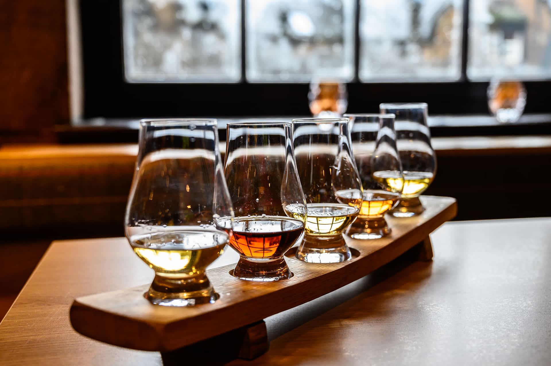 Glasses of Scotch whisky ready to sample at a distillery tour in Scotland. Glasses of Scotch whisky ready to sample at a distillery tour in Scotland.