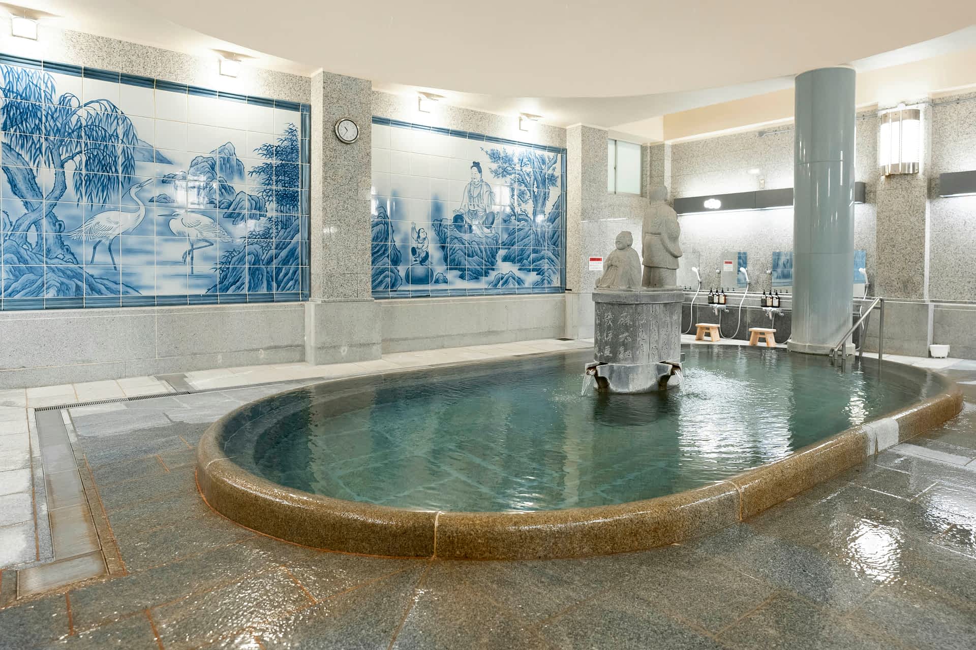 Indoor hot spring surrounded by tiled walls at Dogo Onsen.