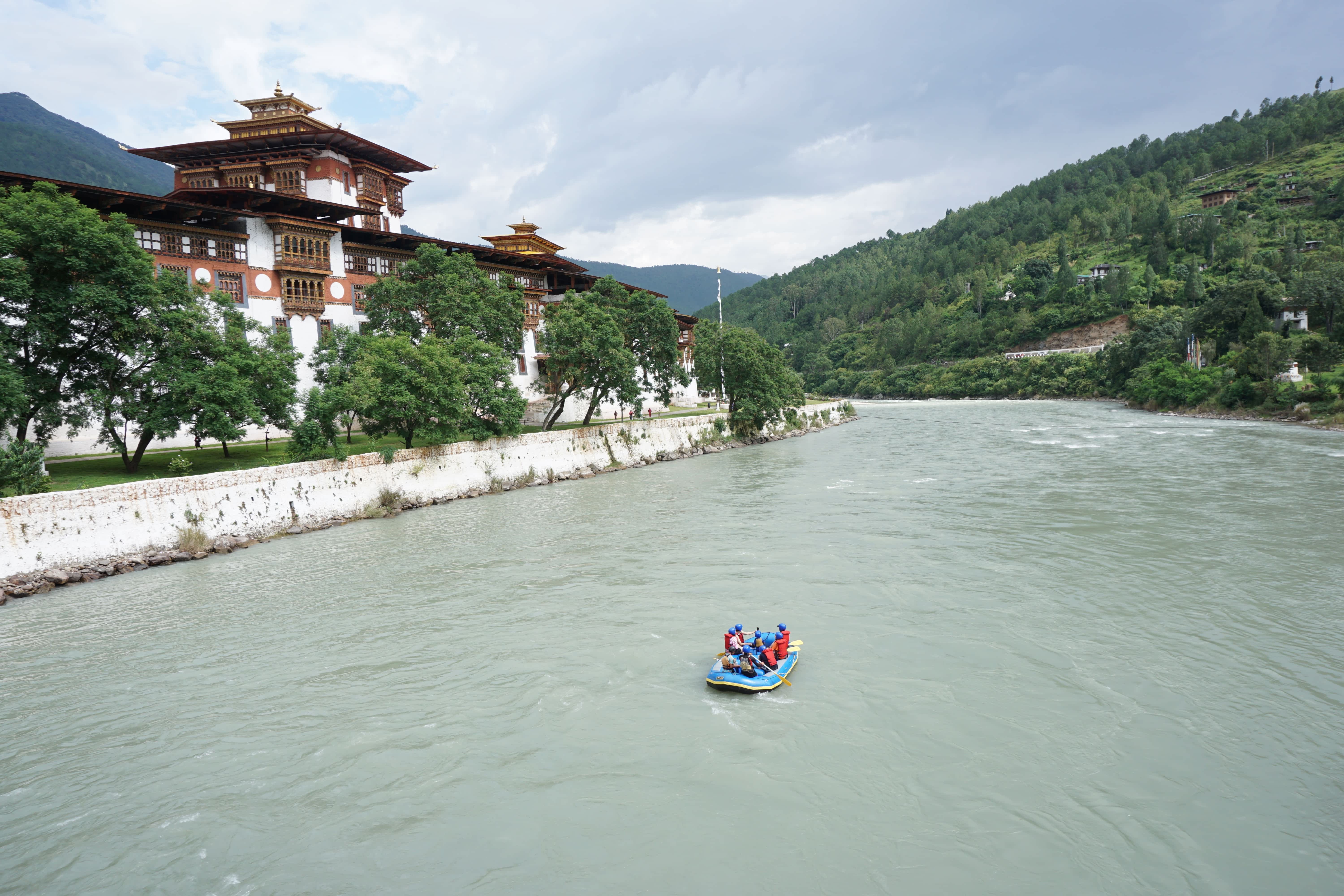Rafting by Punakha Dzong, Punakha, Bhutan A group in a raft by the river in front of Punakha Dzong, Punakha, Bhutan