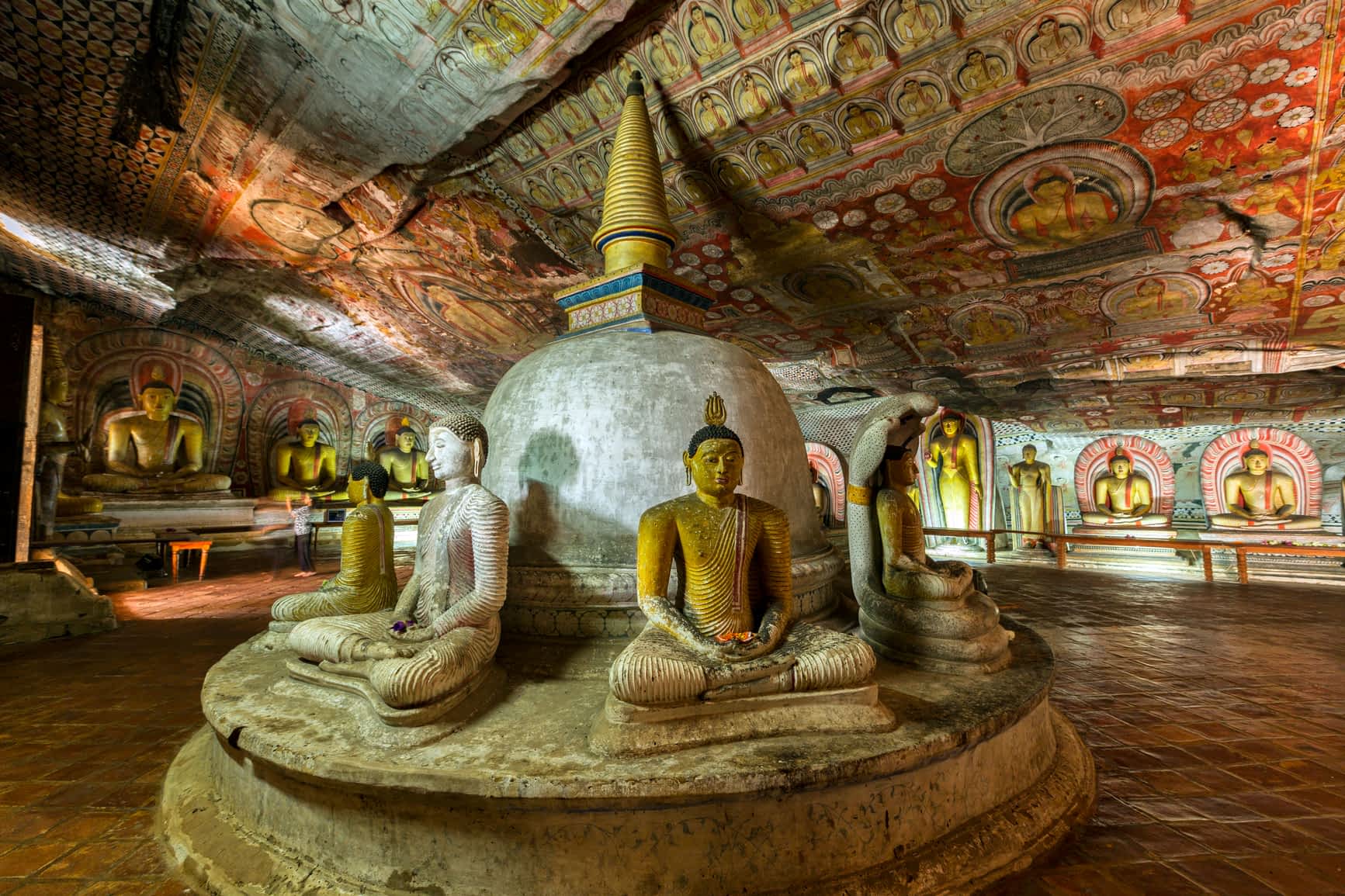 Dambulla caves, Sri Lanka Buddha statues and colorful religious art in the dimly lit caves at Dambulla