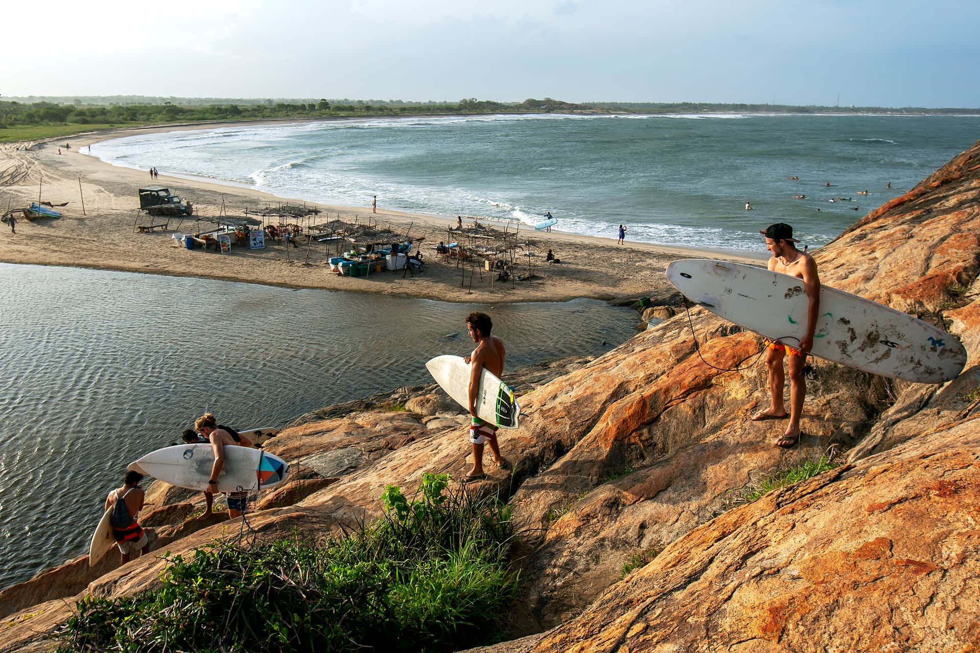 Arugam Bay A group of surfers climb down Elephant Rock towards the beach for a surfing session in Sri Lanka.