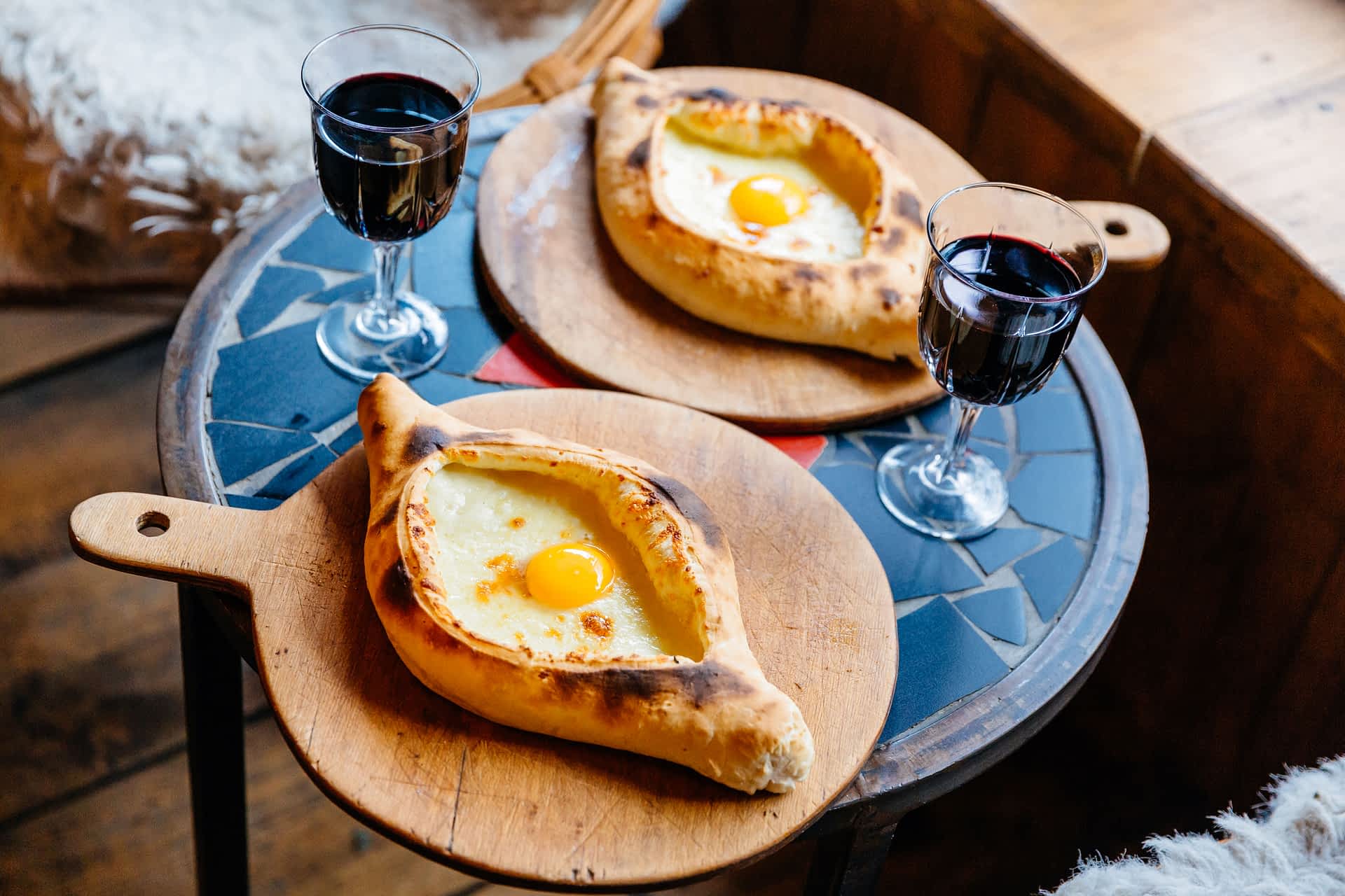 Tbilisi, Georgia A table with Khachapuri and red wine in Tbilisi, Georgia.
