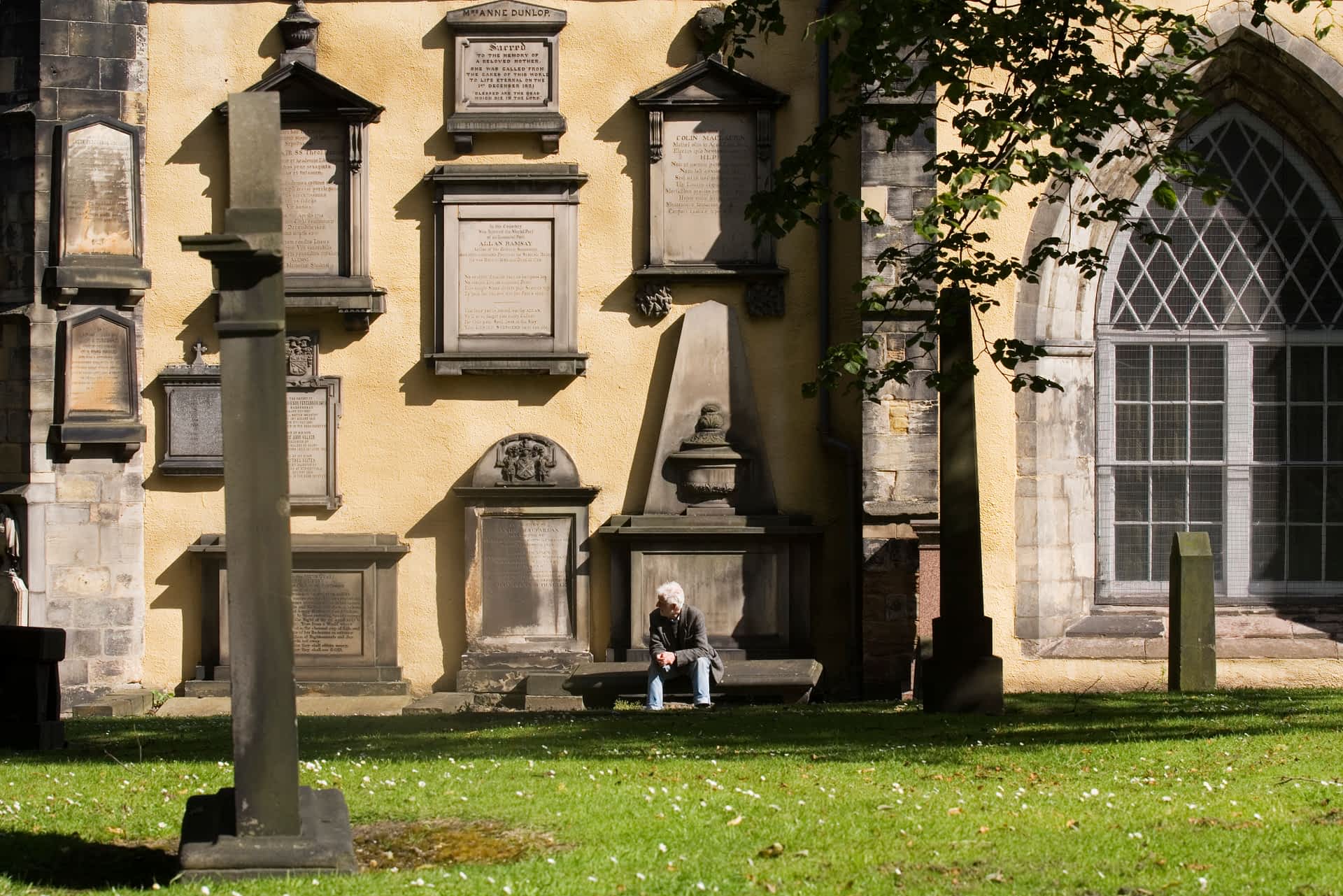 The Greyfriars Kirkyard was a source of inspiration for the writer of Harry Potter. A man rests on a bench in the Greyfriars Kirkyard.