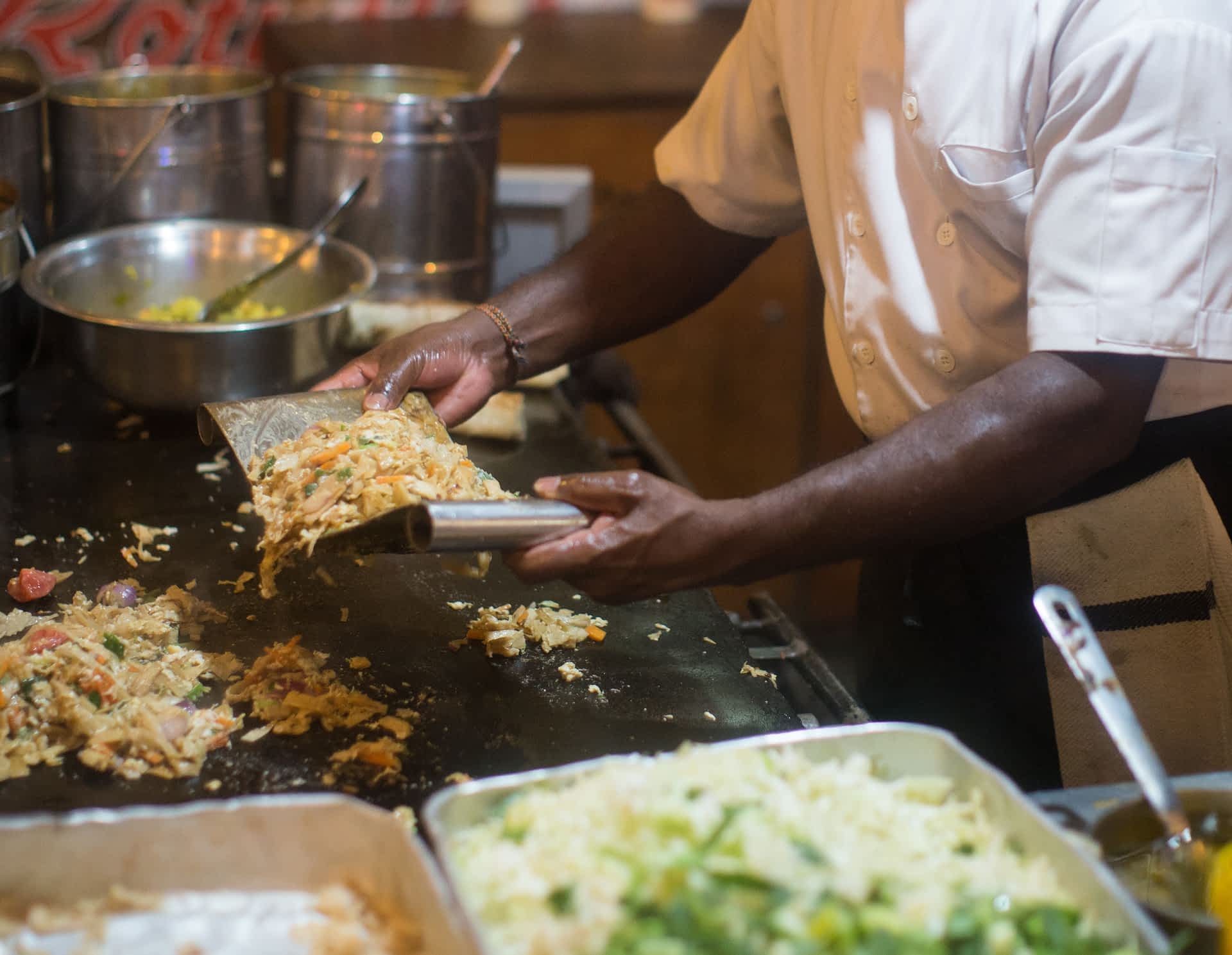 Kottu roti street food, Sri Lanka A close up of a chef preparing street food on a griddle