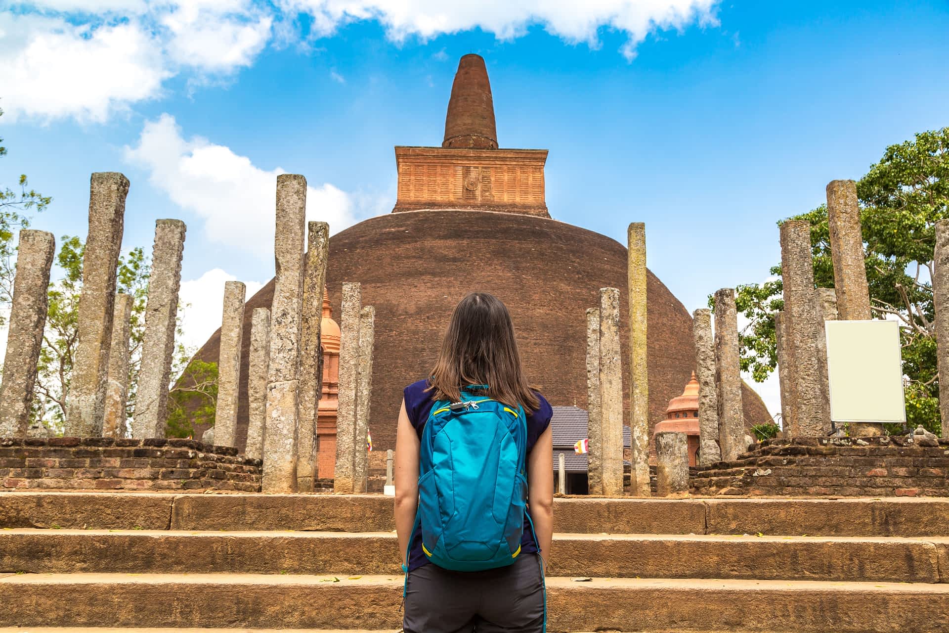 A girl looks at the ruins of the Abhayagiri stupa at Anuradhapura, Sri Lanka. A girl looks at the ruins of the Abhayagiri stupa at Anuradhapura, Sri Lanka.