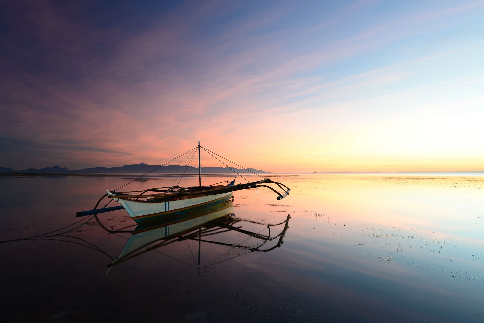 An outrigger boat at sunset on Bohol Island An outrigger boat at sunset on Bohol Island, Philippines