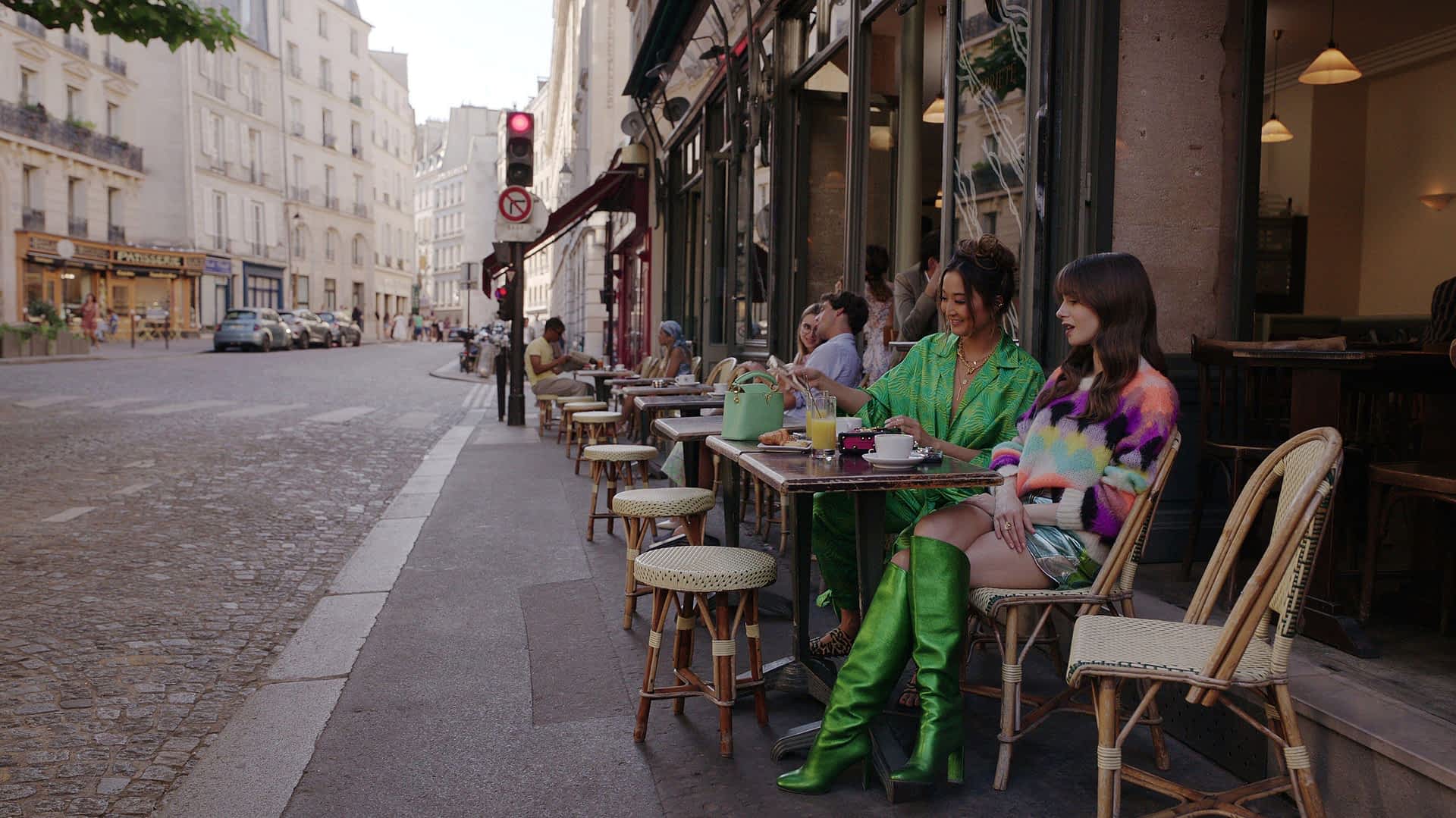 2RFMBKR-RM.jpg Two women sit at pavement tables outside a cafe