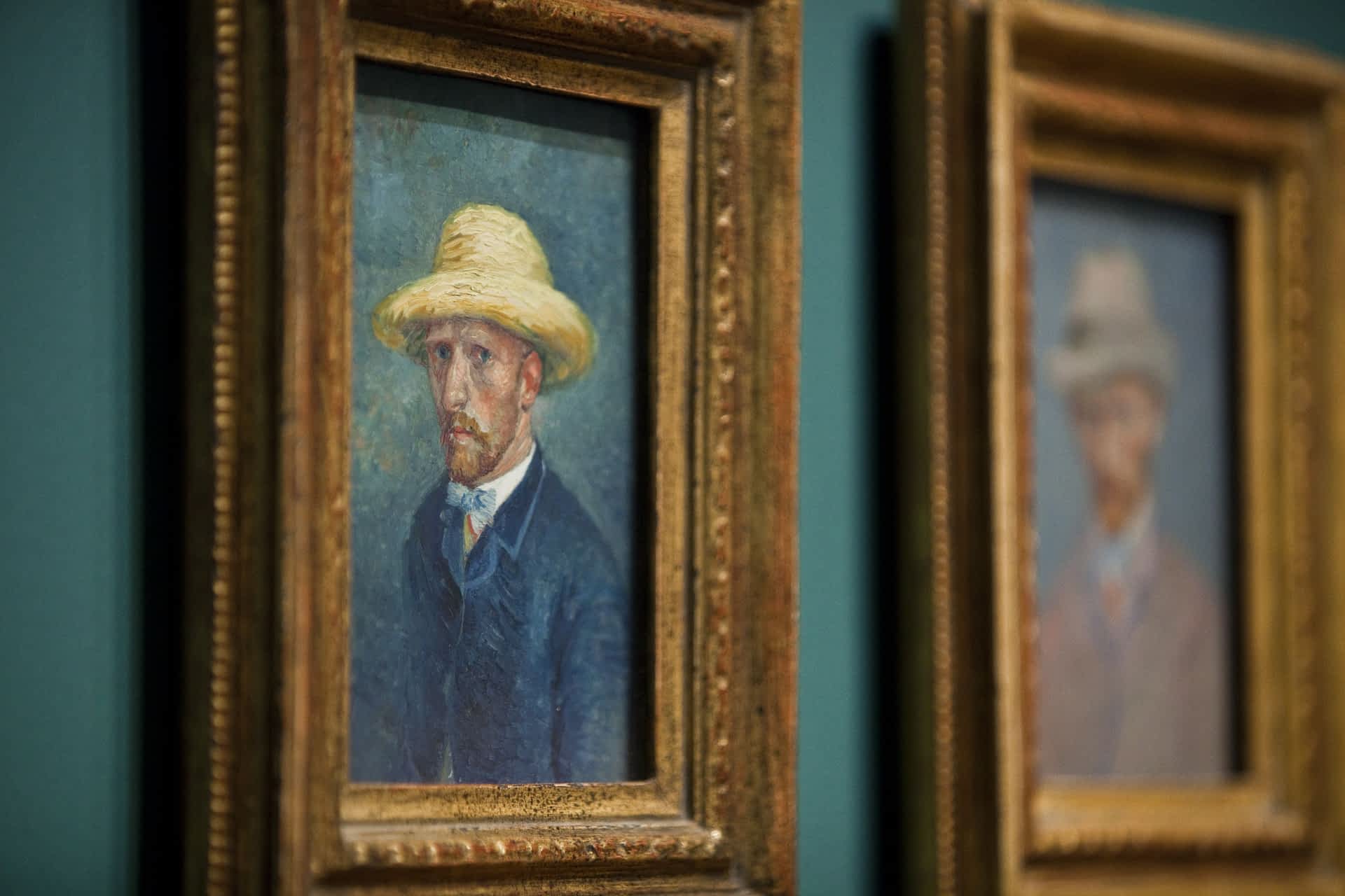 Paintings of dutch painter Vincent van G Two framed self-portraits of Vincent Van Gogh, hanging on the wall in the Van Gogh Museum, Amsterdam.