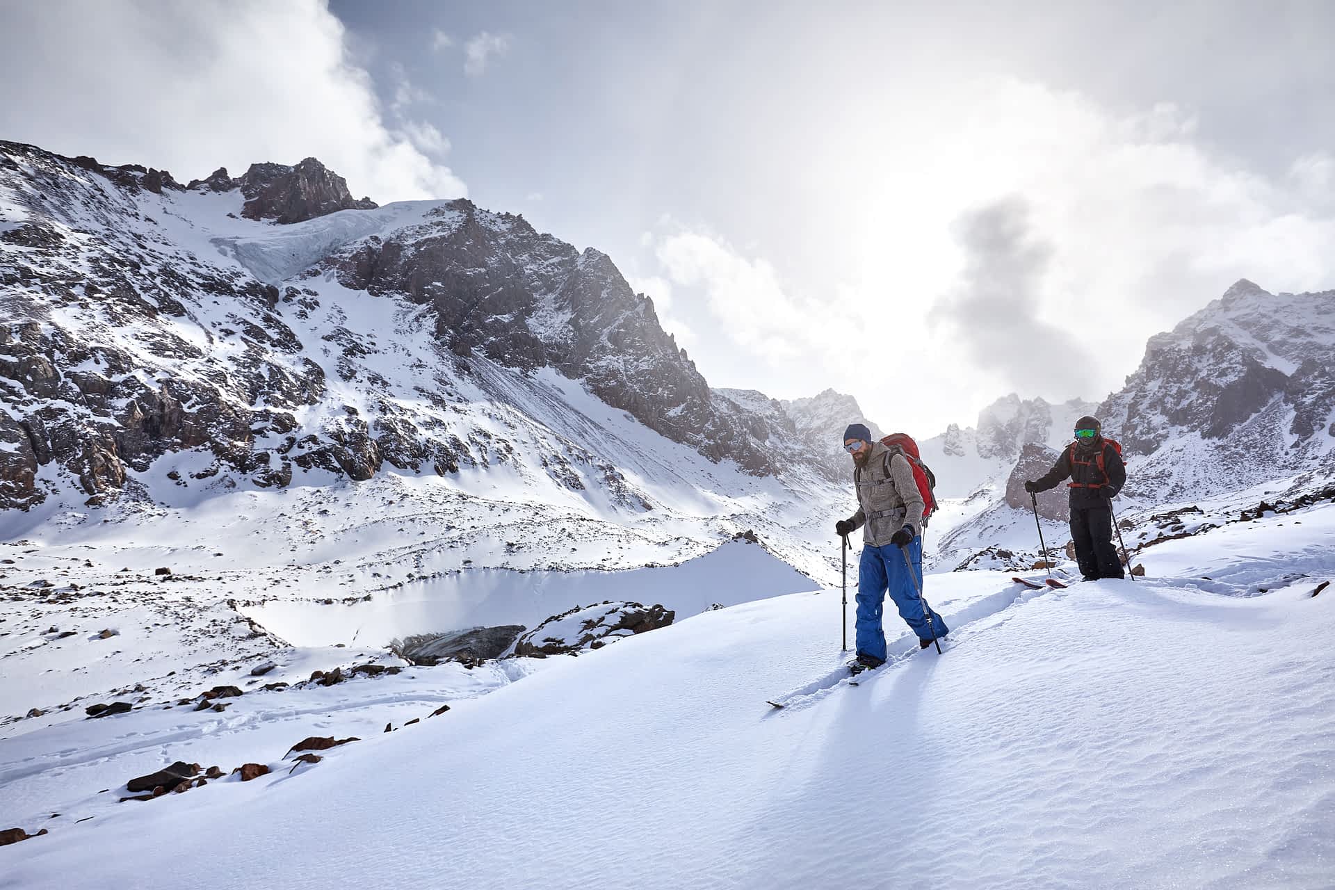 Two men ski touring in the snowy mountains of Kazakhstan