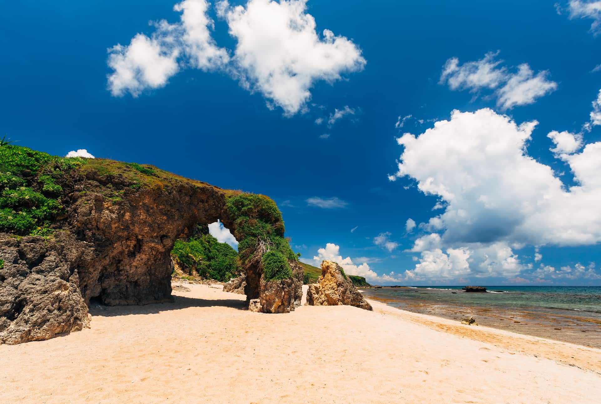The rock arch at Morong Beach on Sabtang Island A view of a sandy beach through a rock arch on Sabtang Island, Philippines