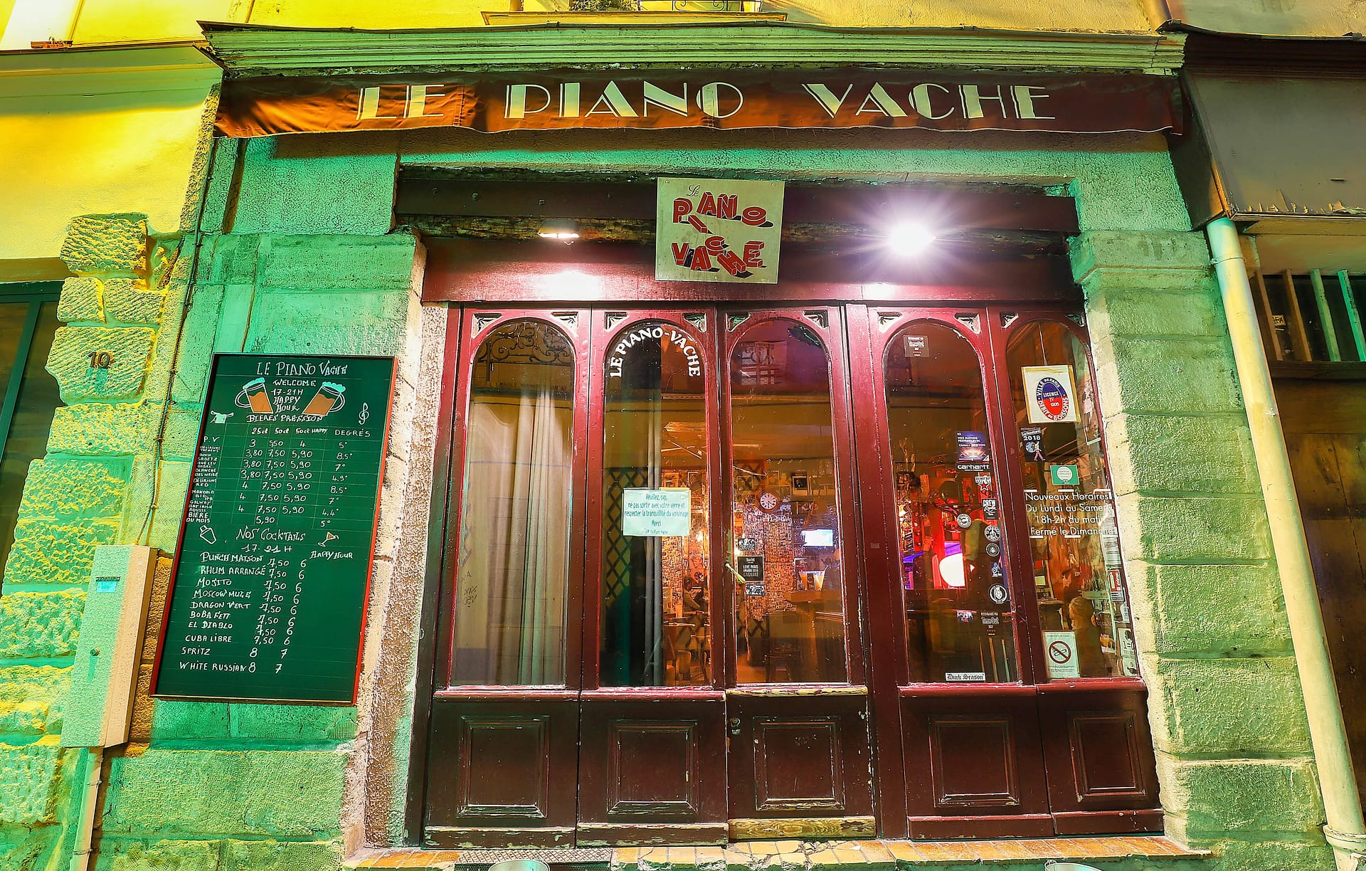 Le-Piano-Vache.png Exterior shot of classic French cafe at night, Le Piano Vache