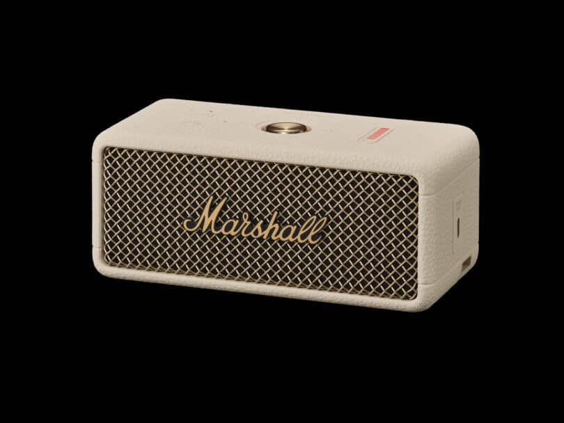 A beige rectangular Marshall wireless speaker with a mesh front and control knob on top.