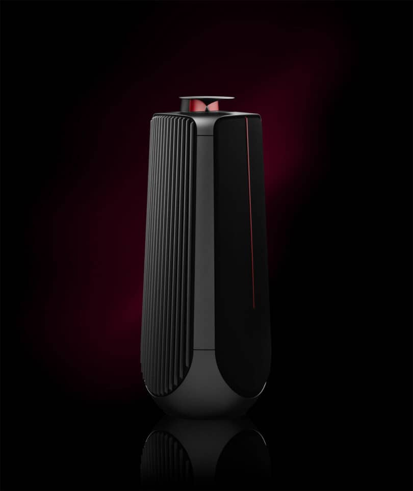 Sleek black and red speaker with a vertical ribbed design, reminiscent of a Ferrari's elegance, set against a dark gradient background.