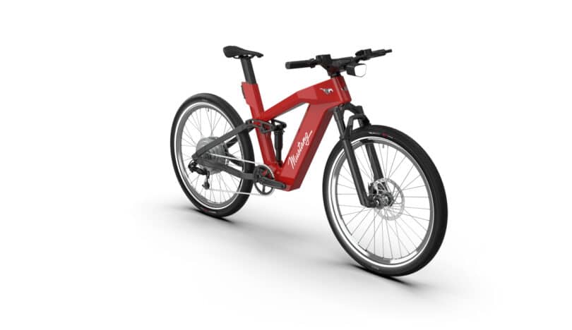A sleek red and black electric bicycle with a modern design, featuring large wheels and a streamlined frame, viewed from a three-quarter angle.